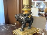 an elephant statue on top of a table next to a lamp