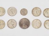 a group of coins sitting on top of a white surface