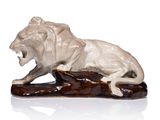 statue of a lion on a log on a white background