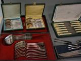 many different types of silverware in a case