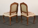 pair of antique chairs with floral upholstered upholstered seats