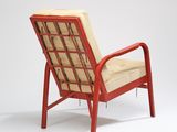 an image of a red chair with a beige cushion on it
