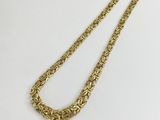 a gold necklace with a chain that is attached to it