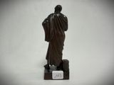 an image of a statue of a man standing on a block