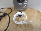 a smart watch sitting on top of a table next to a charger