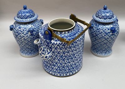 trois vases bleus et blancs avec leurs couvercles, posés sur une table