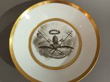 une assiette sur laquelle est représenté un homme et un oiseau