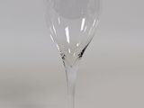 a wine glass sitting on a table with a white background