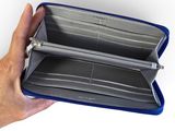 someone is holding a wallet in their hand on a white background