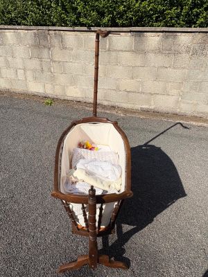a baby in a crib in the middle of a parking lot