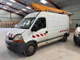two vans parked in a warehouse with a crane on top of them