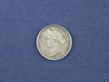 a close up of a coin on a blue cloth