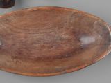 a wooden bowl and a wooden spoon on a table