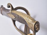 a gold colored sword with a knot on the handle
