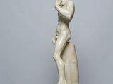 marble statue of a man holding a bird on a pedestal