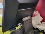 a computer monitor sitting on top of a desk next to a mouse