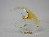a glass sculpture of a fish on a white surface