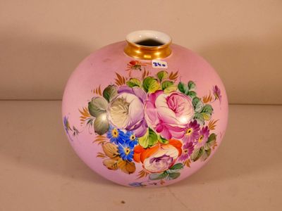 a pink vase with flowers painted on it sitting on a table
