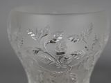 a glass vase with a design on it on a table