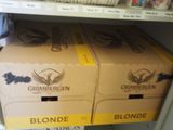 boxes of beer are stacked on top of each other on a shelf