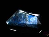 an image of a blue stone on a black background