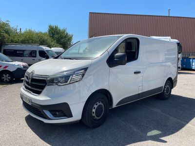 a white van parked in a parking lot next to a building