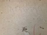 a graffiti on the floor of a bathroom with a toilet and a trash can