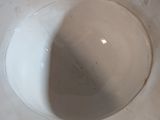 a white toilet bowl with the lid down