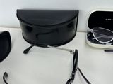 glasses, a case, and a pair of glasses are on a table