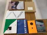 many books on a table with a laptop on it
