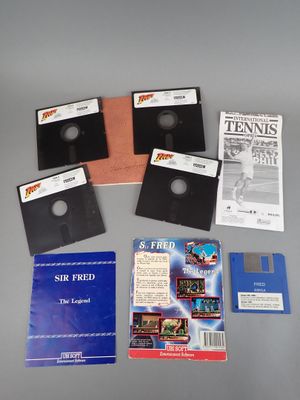 four floppy disks and a book on a table