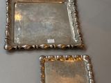 pair of silver plated trays on a table with a label on it