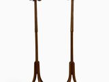 pair of tall wooden coat stands with deer heads on them