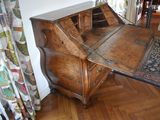 a wooden desk with a wooden top and a rug on the floor
