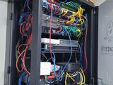a black cabinet with many wires and wires in it
