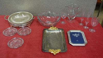 a red table with a red table cloth and silver trays and glasses
