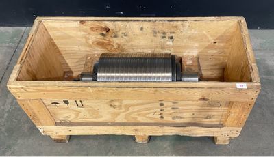 a wooden box with a metal object inside of it
