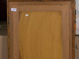a picture of a painting on a table with boxes in the background