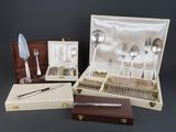 a box with silverware and a knife and spoons in it
