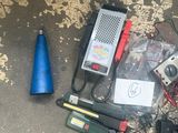 a lot of electrical equipment on the ground next to a blue cone