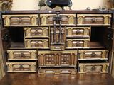 a large wooden chest with many drawers on top of it