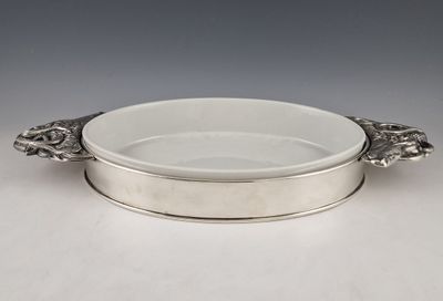 a silver plate with a handle and handles on a table