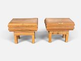 two small wooden stools sitting side by side on a white surface