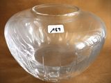 a clear glass vase with a sticker on it