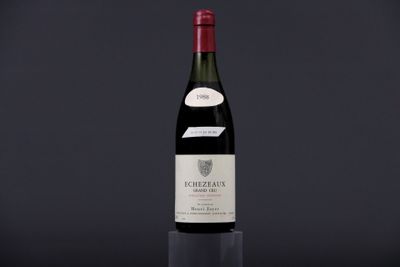 a bottle of wine sitting on top of a wooden table