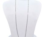 a close up of a necklace on a mannequin with a white background