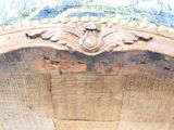 a close up of a wooden chair with a blue and white cover