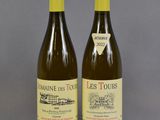 two bottles of wine sitting on top of a table next to each other