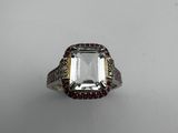 an emerald and diamond ring with two rows of diamonds around it