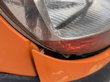 a close up of a car ' s headlight and front bumper